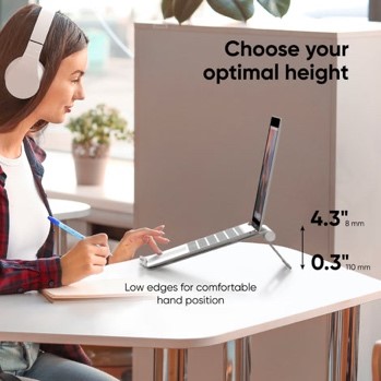 Photo of a woman using a small laptop riser for better positioning