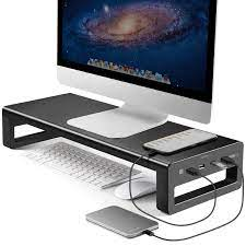 Photo of a monitor on a stand lifting it off the desk