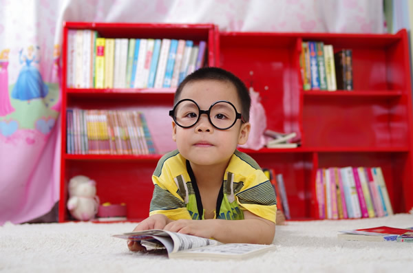 Child with glasses reading